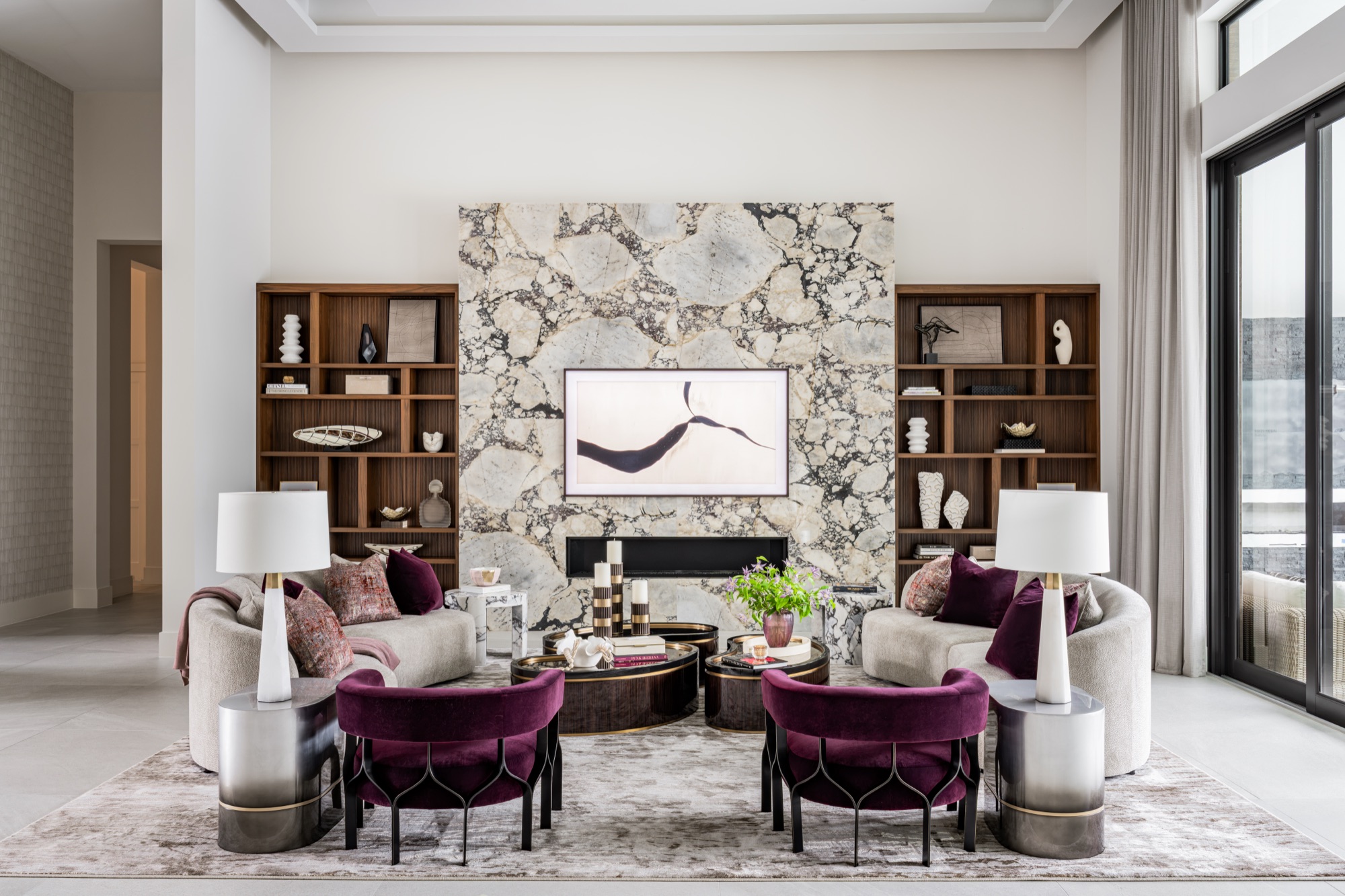 Living room with full-height Calacatta Viola fireplace wall flanked by walnut built-ins, Boca Raton